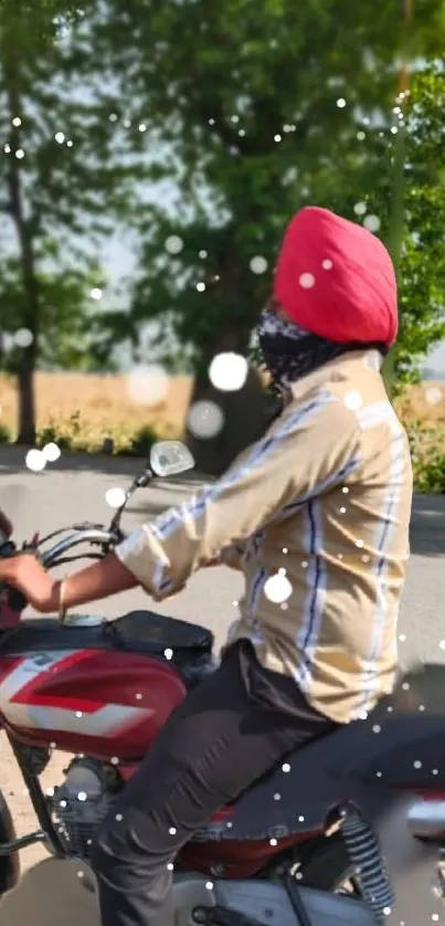 Man with red turban rides a motorbike with a snow effect in nature.