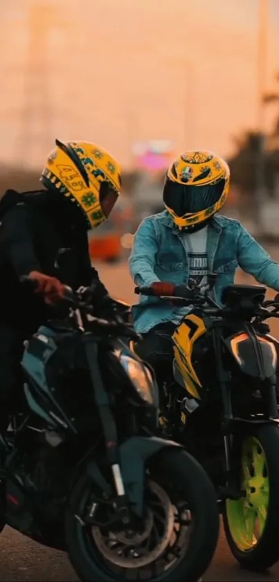 Two motorbike riders at sunset with vibrant helmets.