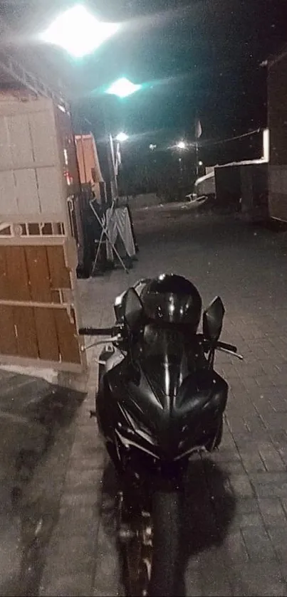 Sleek black motorcycle under streetlights at night.