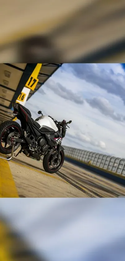 Motorcycle on an open road under a blue sky.