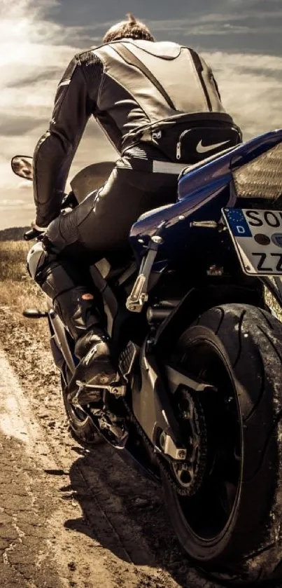 Motorcyclist rides along open road under expansive sky.