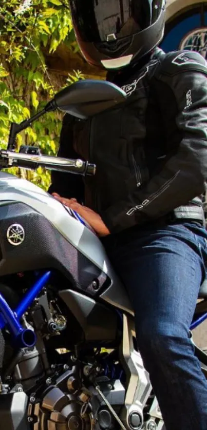 Motorcycle rider in black gear on a road.