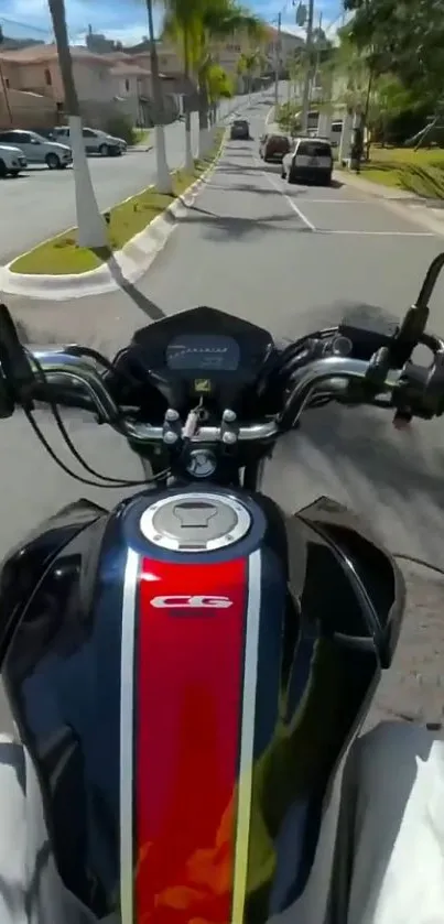 Motorcycle view on an urban road with vibrant red bike design.