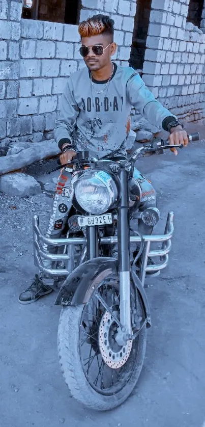 A young man rides a motorcycle in a rustic urban setting, showcasing cool style.