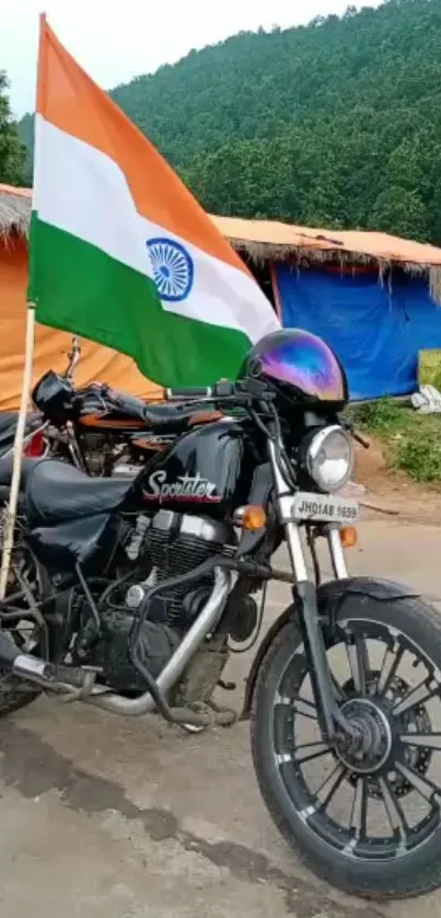 Motorcycle with Indian flag against scenic backdrop.