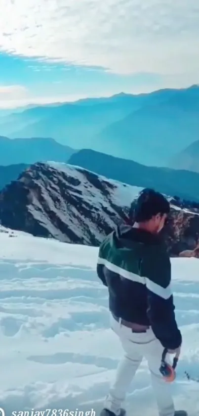 Man exploring snow-covered mountains under a blue sky.