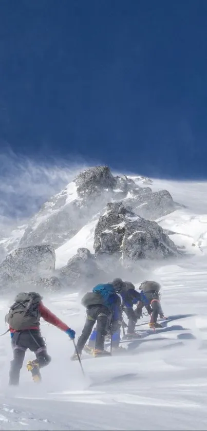 Climbers ascending a snowy mountain with clear blue skies.