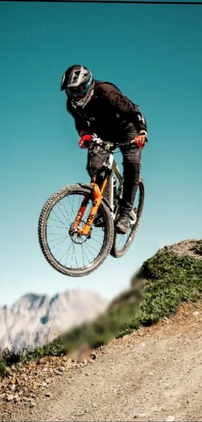 Mountain biker jumps against scenic backdrop.