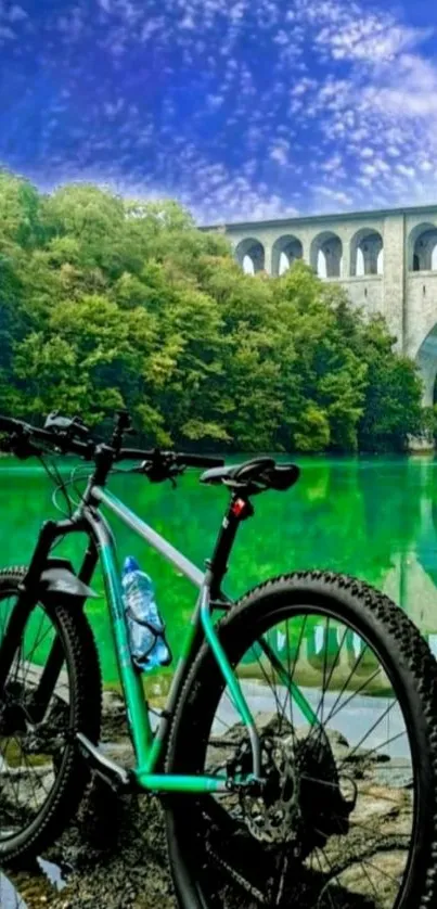 Green mountain bike by stone bridge over calm river.