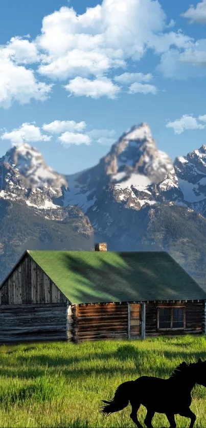 Mountain cabin with horse silhouette under a blue sky and mountains.