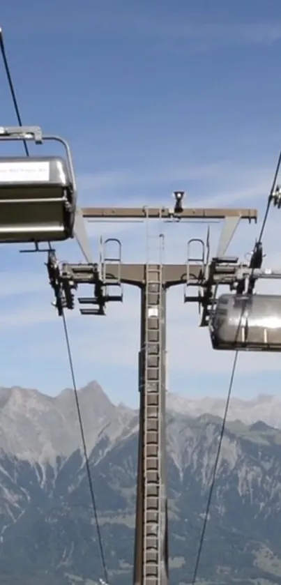 Cable car ascending over scenic mountain landscape with blue sky.