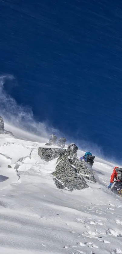 Climbers conquering a snowy mountain under a vivid blue sky.