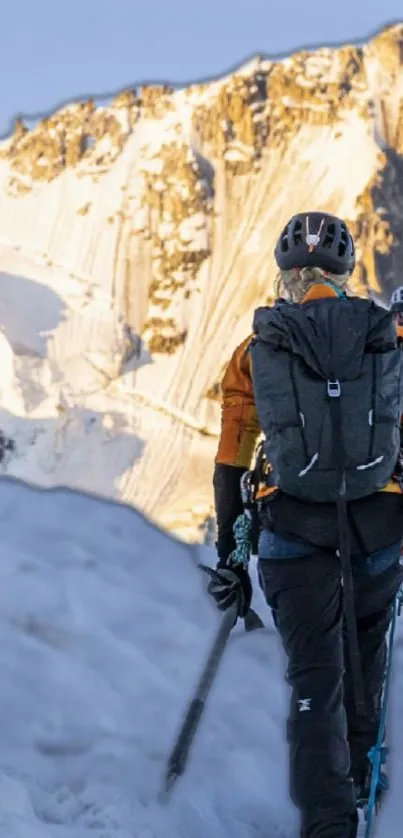 Climbers ascending a snowy mountain with gear at sunrise.