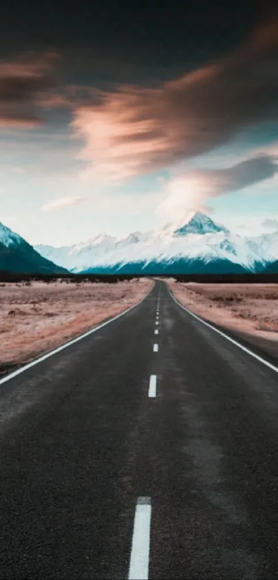 Road leading to mountains under a vibrant sunset sky.