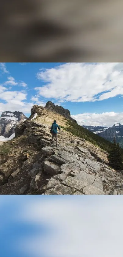 Hiker on rocky mountain trail under a clear, scenic sky.