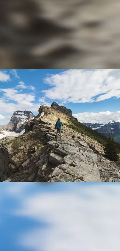 Hiker stands on rocky mountain ridge under a bright blue sky.