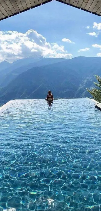 Infinity pool with mountain view and a serene sky backdrop.