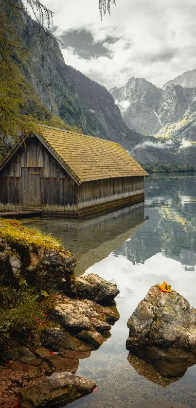 Serenely reflective lake with mountain cabin.