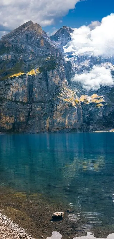 Scenic view of a mountain lake with clear blue water and towering peaks.