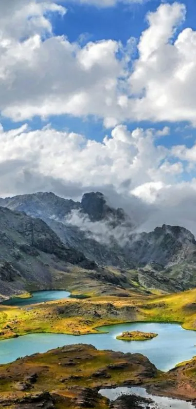 Scenic mountain lake with clouds and greenery.