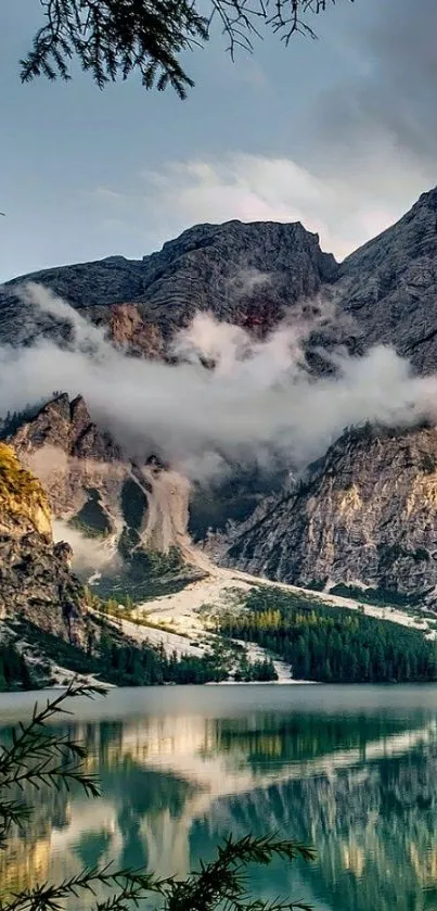 Scenic mountain lake with misty peaks and clouds in a calming nature setting.