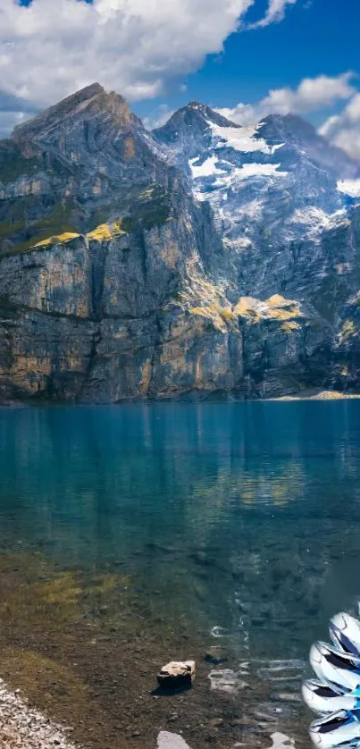 A serene mountain lake under a vivid blue sky with rocky peaks, ideal for phone wallpaper.