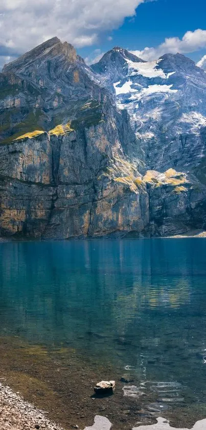 Serene mountain lake with rocky peaks and clear blue water.