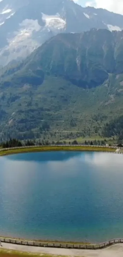 Tranquil mountain lake with forest and peaks.