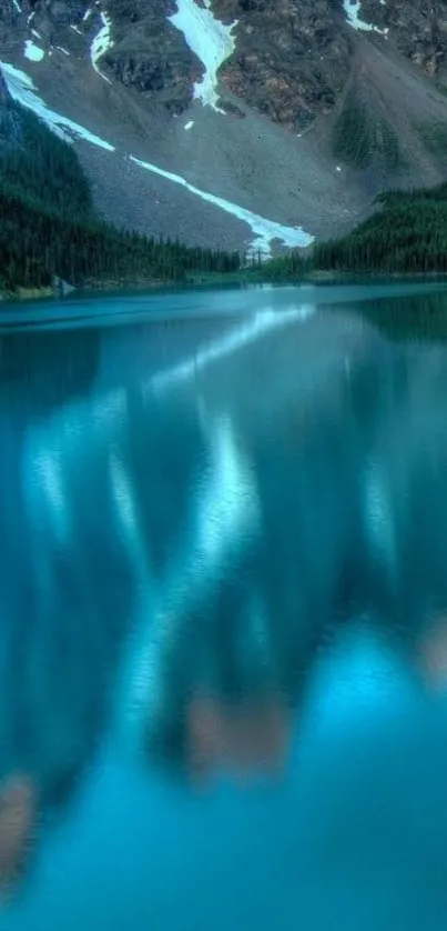 Serene mountain lake with blue water reflection.