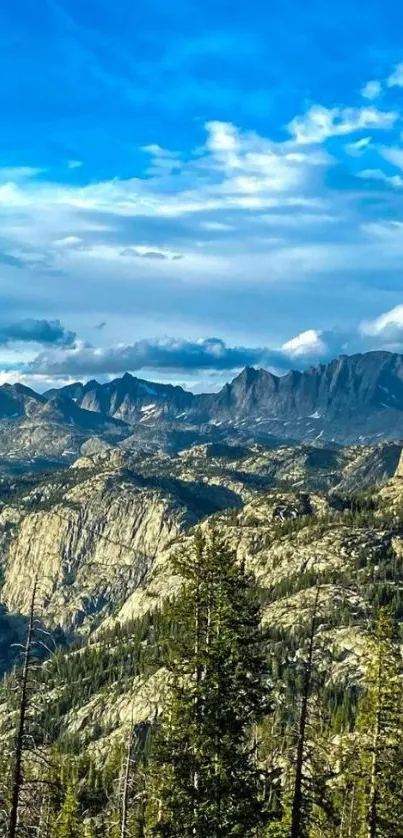 Majestic mountain range under a vibrant blue sky with lush greenery.