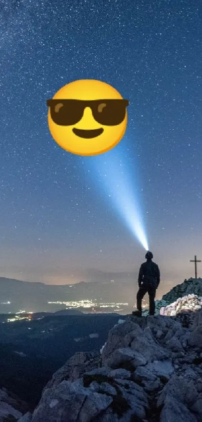 Person on mountain peak under starry night sky with city lights.