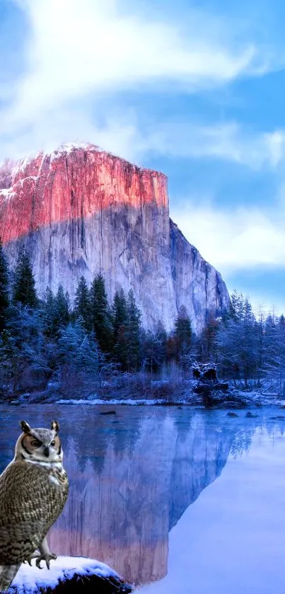 Owl perches by lake with snowcapped mountain view.