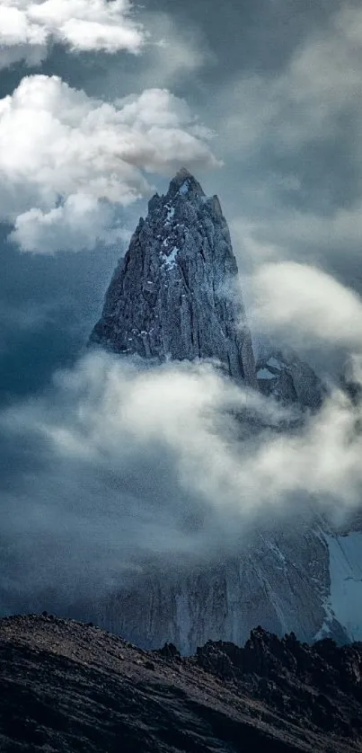 Misty mountain peak surrounded by dramatic clouds.