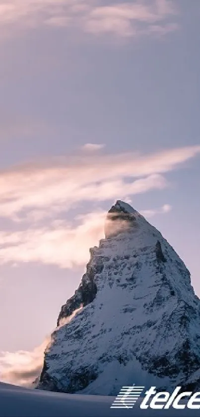 Majestic mountain peak at sunset with purple sky.