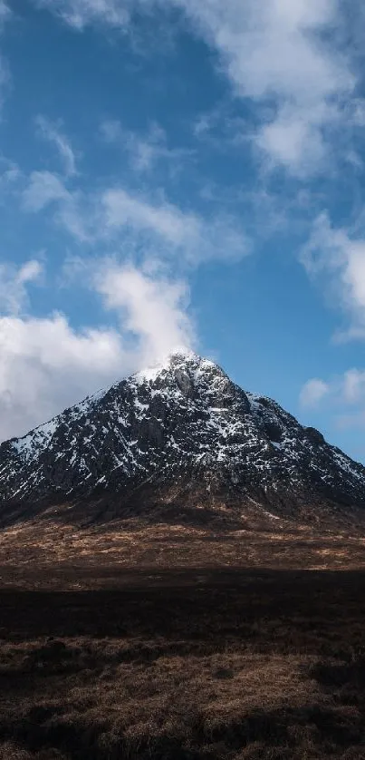 Snow-capped mountain under a blue sky.