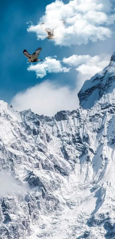 Snow-covered mountains with eagles in a bright blue sky.