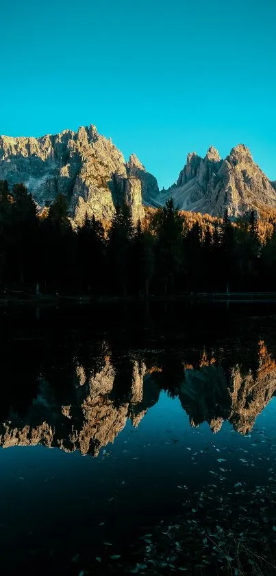 Mountain reflection over a serene lake with teal sky.