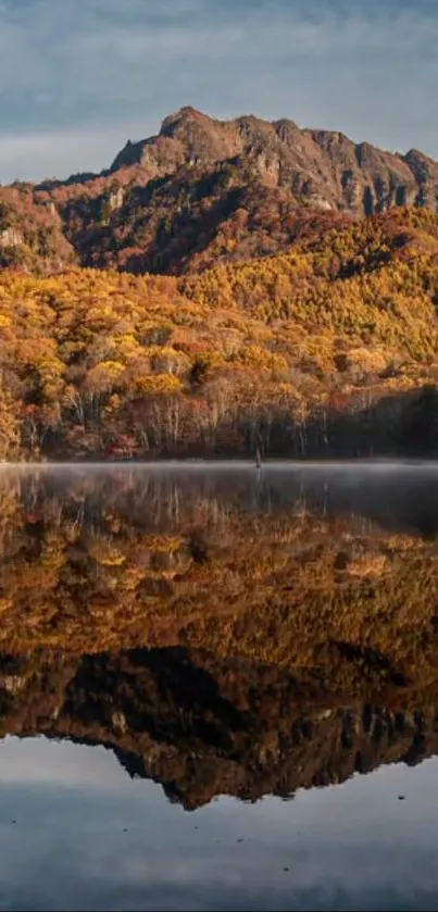 Mountain landscape with reflection in calm lake waters during autumn.