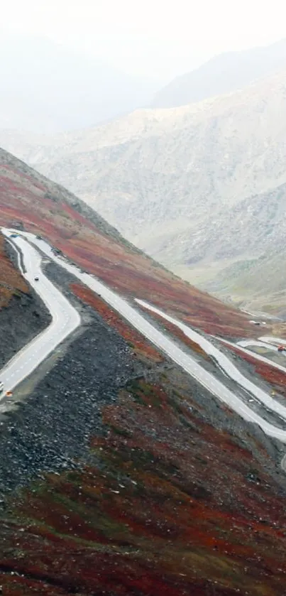 Winding mountain road through autumn hills scenery.