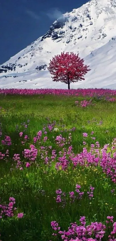 Majestic mountain with pink tree and purple flowers in a green field.