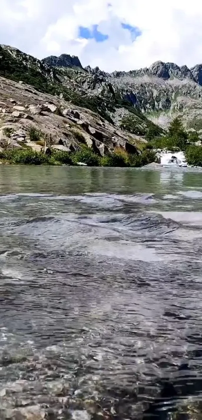 Serene mountain stream with peaceful water and rugged, majestic peaks.