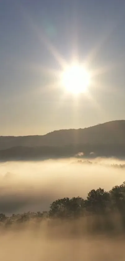 Mountain sunrise with mist and sun rays illuminating the scenic landscape.