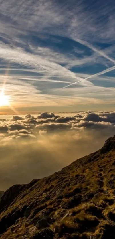 Stunning mountain sunrise with clouds and a glowing sky.