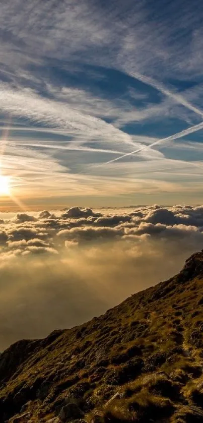 Sunrise over mountains with clouds and golden rays in the sky.