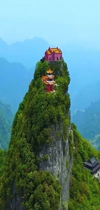 Temple on a lush green mountain with misty horizon.