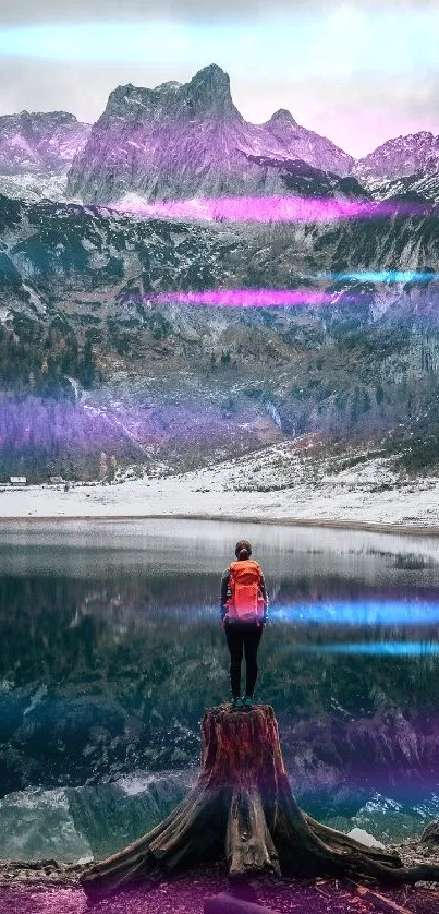 Person stands on stump overlooking a purple-hued mountain and lake reflection.