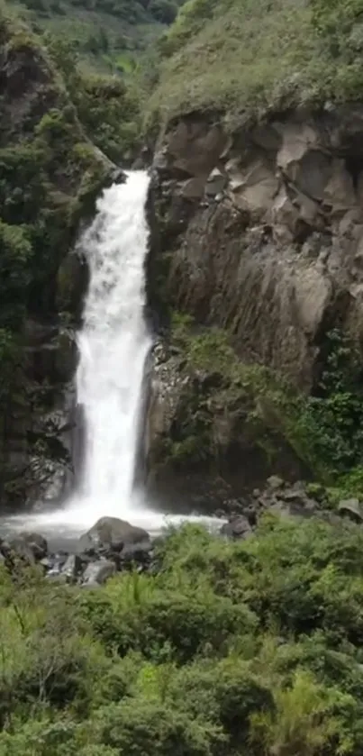 Scenic mountain waterfall with lush greenery.