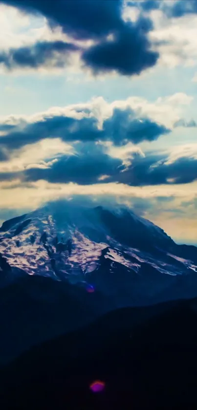 Snowy mountain peak with cloudy sky background.