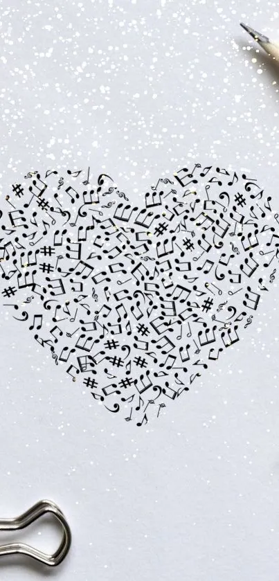 Heart-shaped music notes on white paper with stationery items.