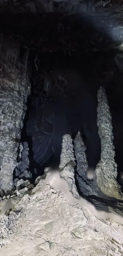 Stalactites in a dark cave with mysterious shadows.